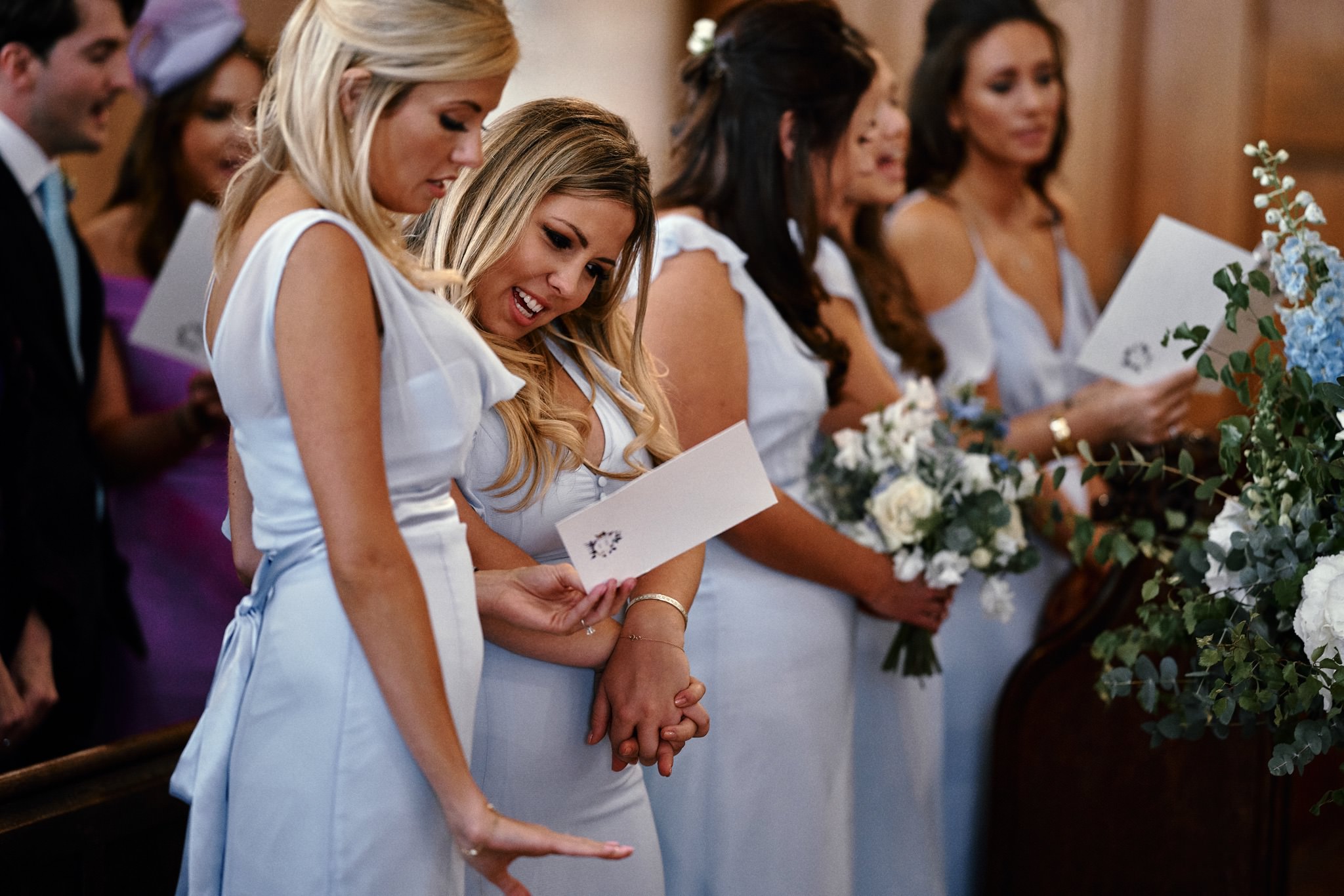 Bridesmaids singing during a wedding service at St Mary's Church, Henley-on-Thames