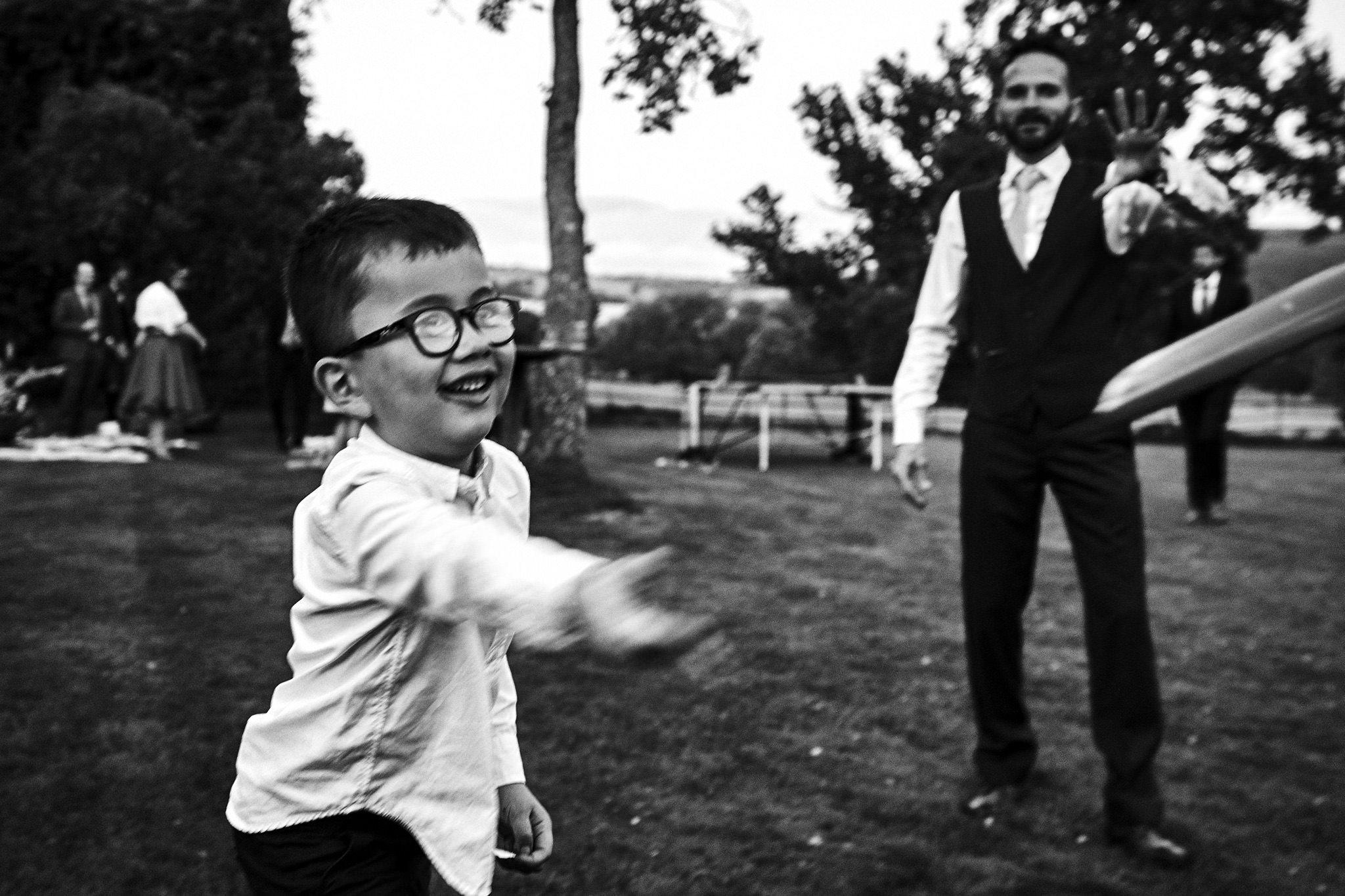 Kid throws frisbee during wedding reception